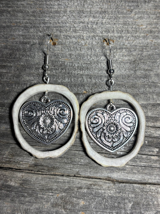 Silver heart shaped charm with flower design